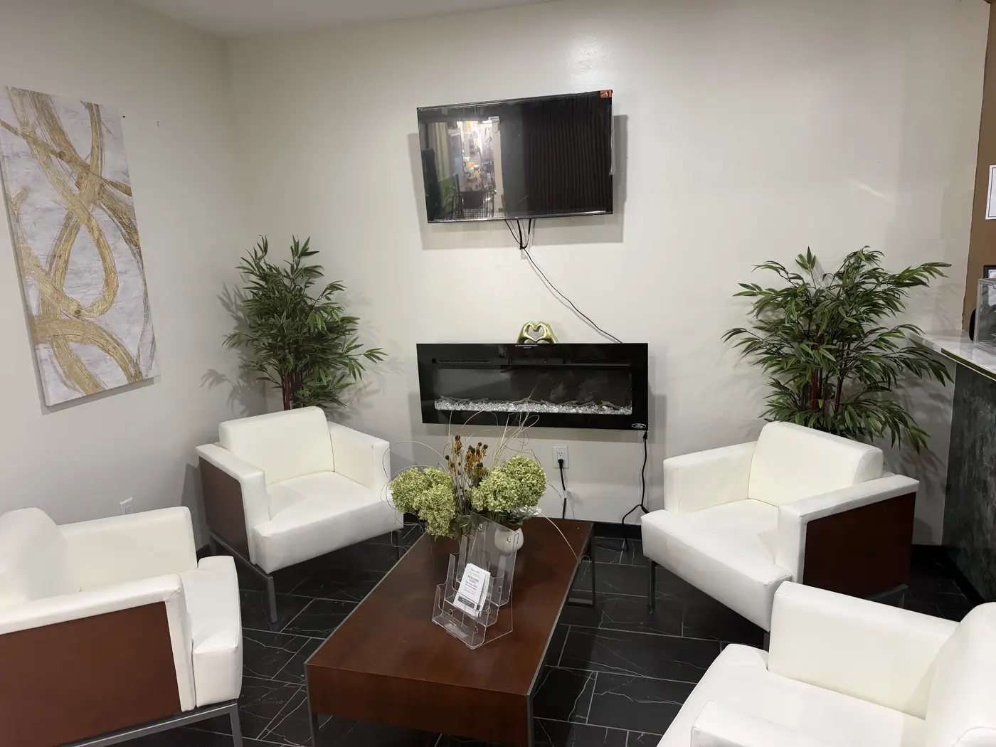 White lounge chairs around the fireplace at Oak